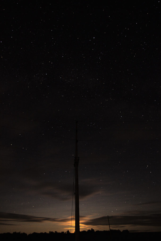 The moon, rising behind a hydro pole