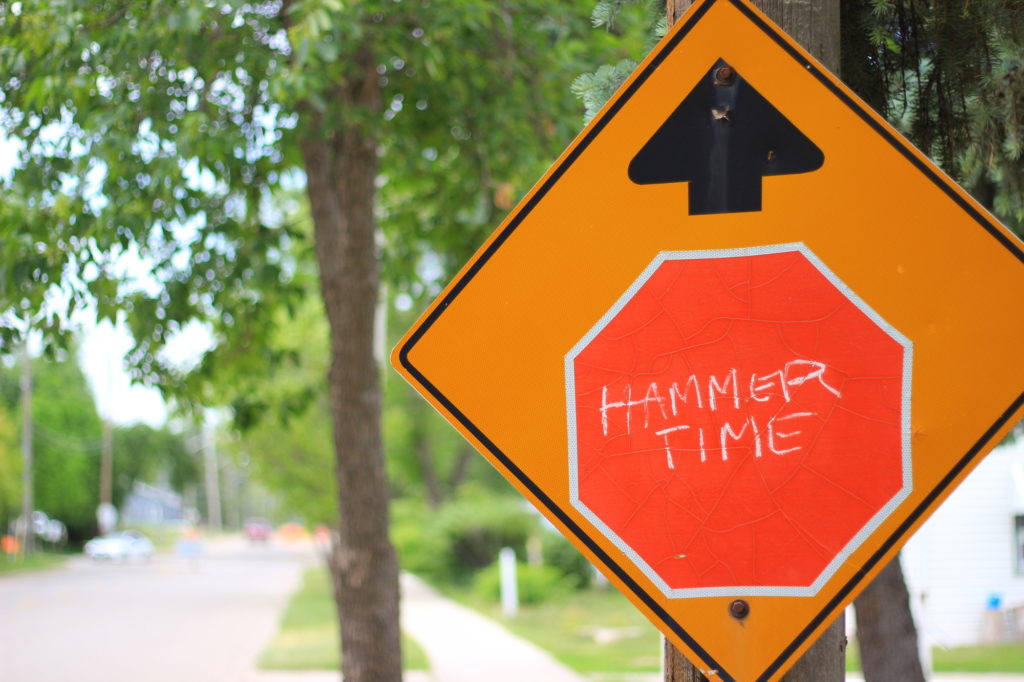 Stop sign with "Hammer Time" written on it in chalk