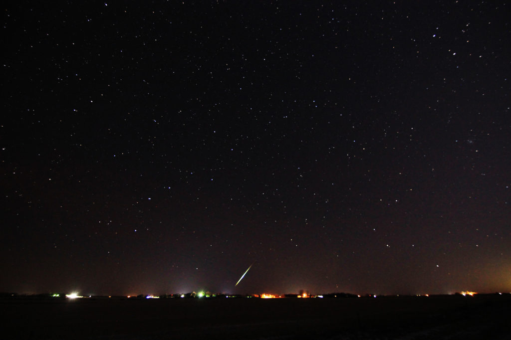 A meteor streaks over the horizon
