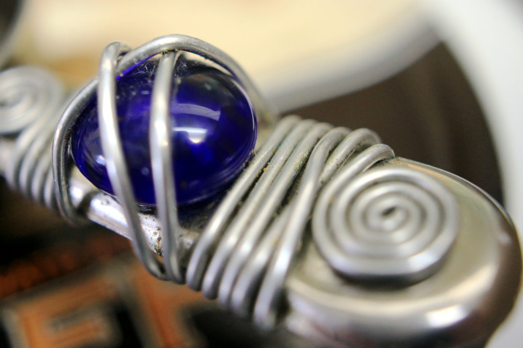 Blue cabochon on coffee scoop (macro)