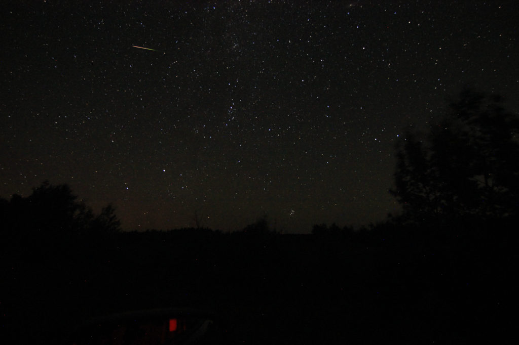 Long shot of a meteor burning up in the sky