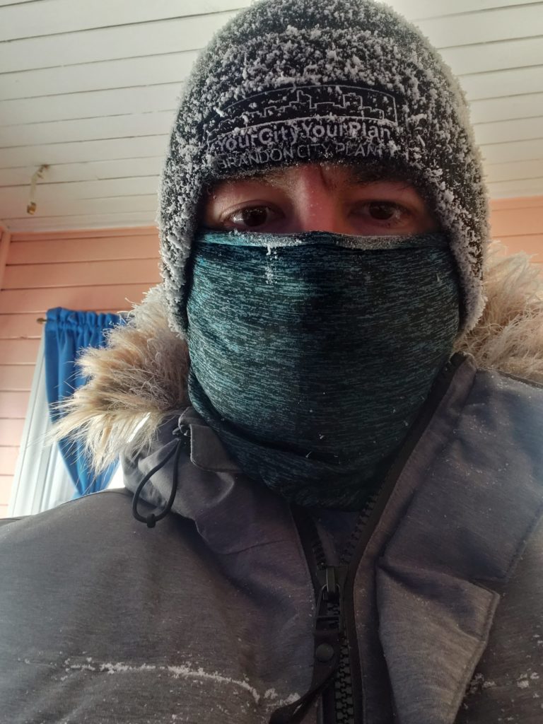 A selfie, wearing my parka, toque, and mask; there's frost on my eyelashes