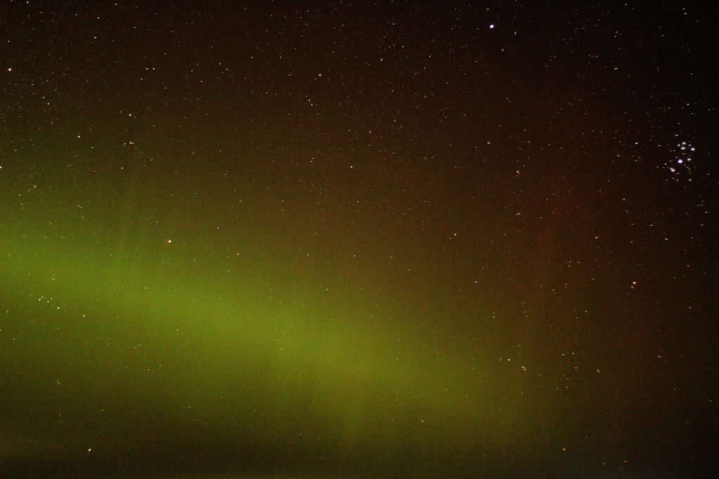 A green band of aurora, and the Pleaides star cluster