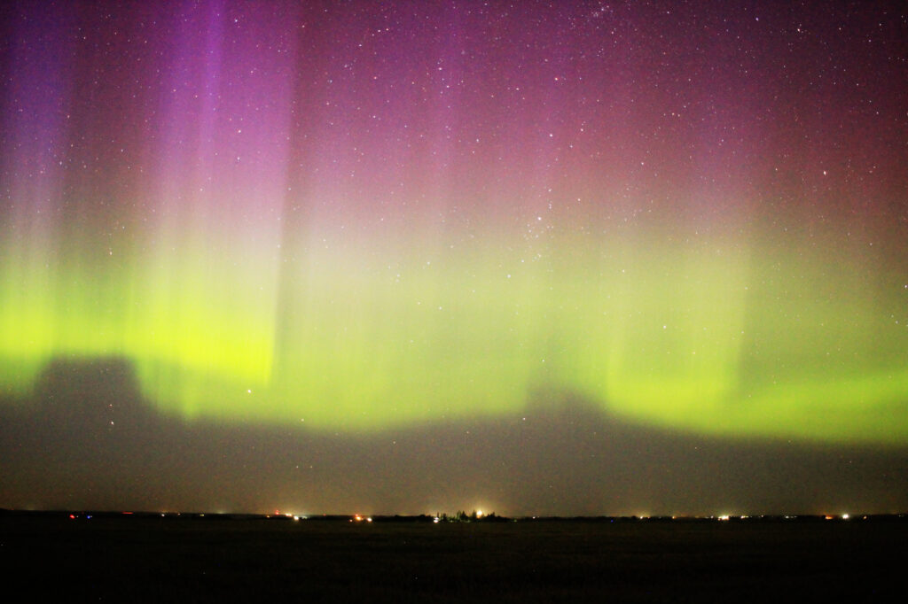 Aurora Borealis: vivid purple pillars above a green band