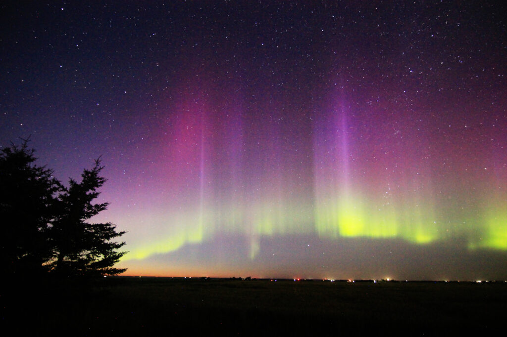 Aurora Borealis: vivid purple pillars above a green band
