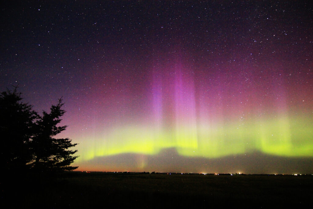 Aurora Borealis: vivid purple pillars above a green band