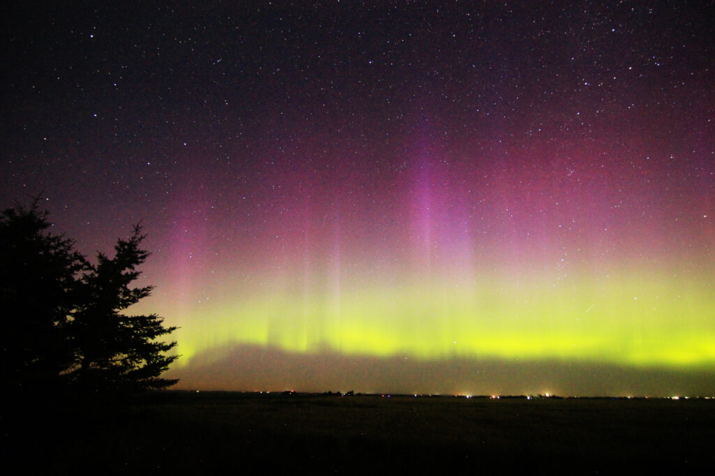 Aurora Borealis: vivid purple pillars above a green band