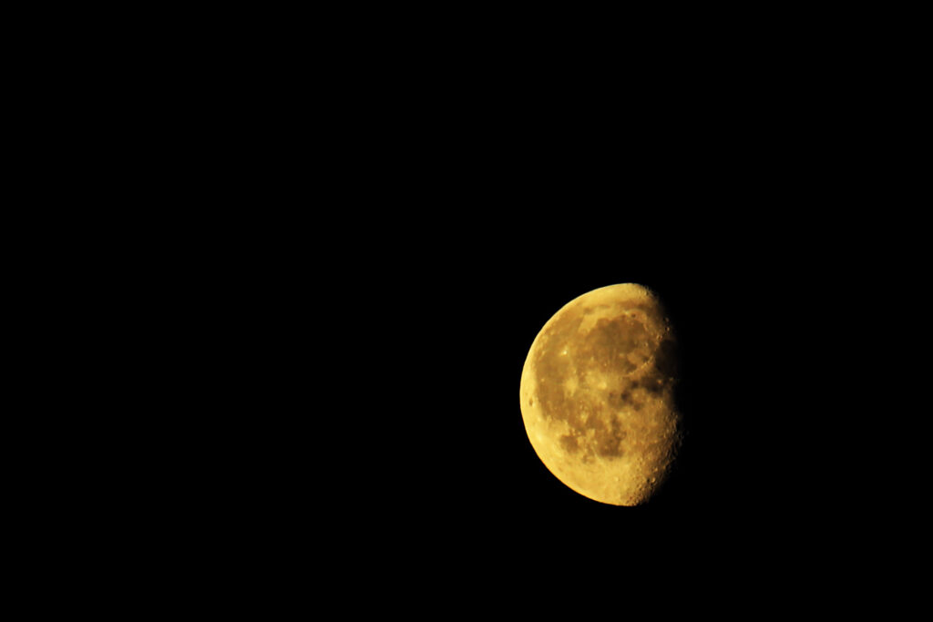 The moon, looking sepia in a black sky