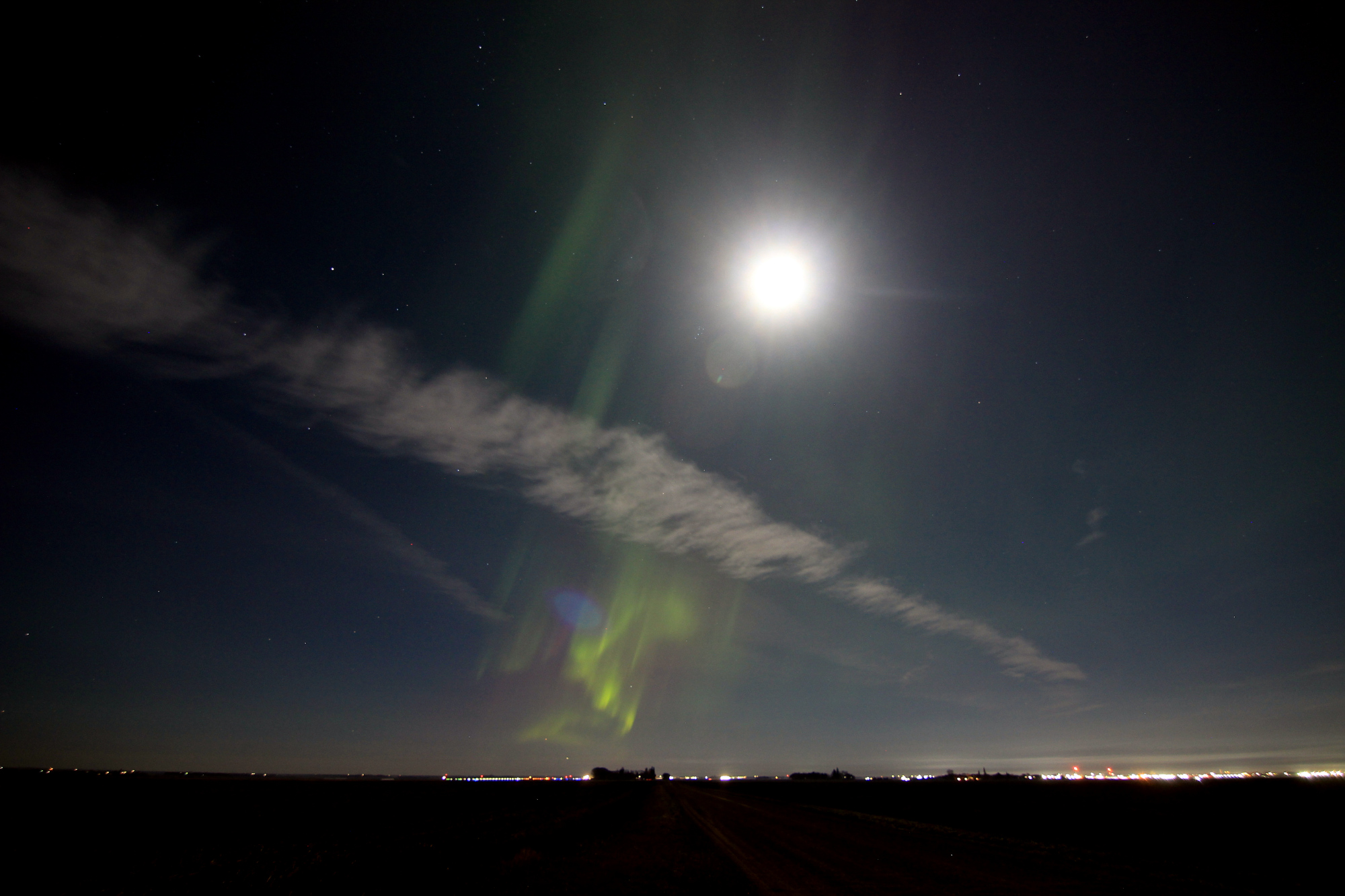 Aurora and the full moon over the prairie