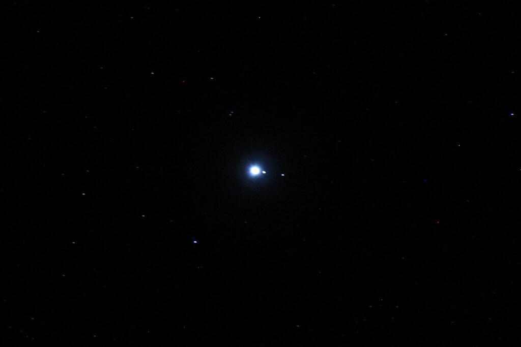Jupiter, with Io and Ganymede visible