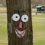 A tree decorated with a grinning face