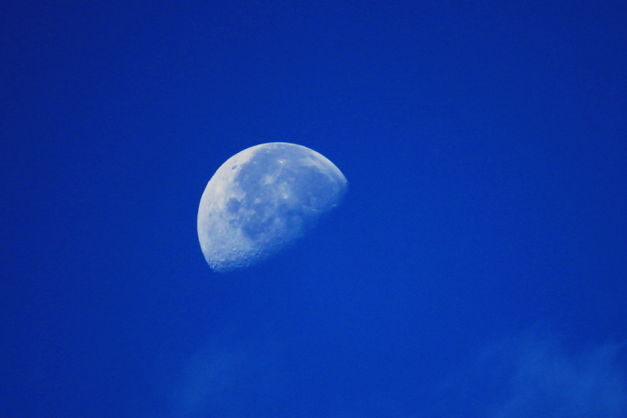 The half-moon in a blue morning sky